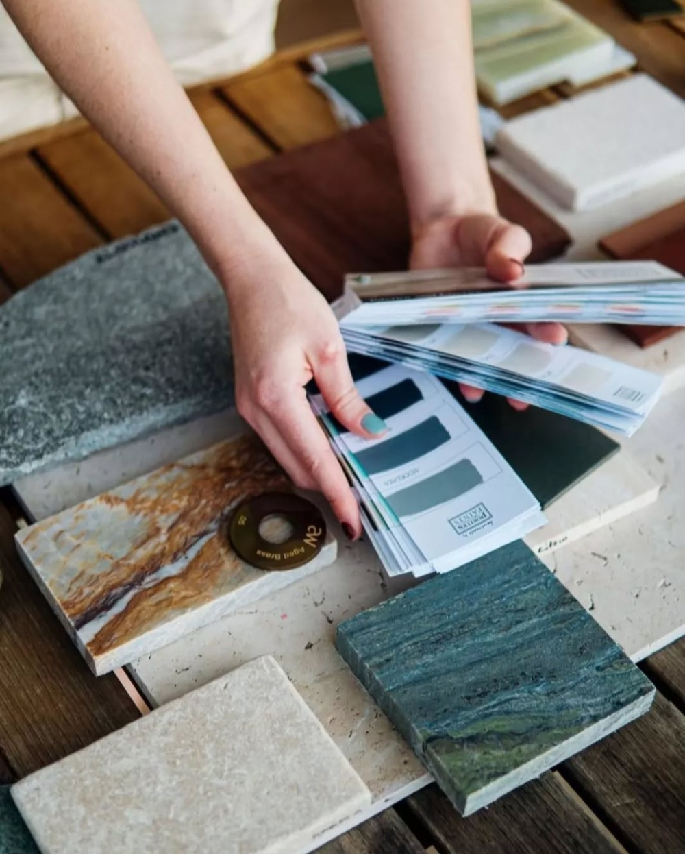 Person holding color swatches over stone samples