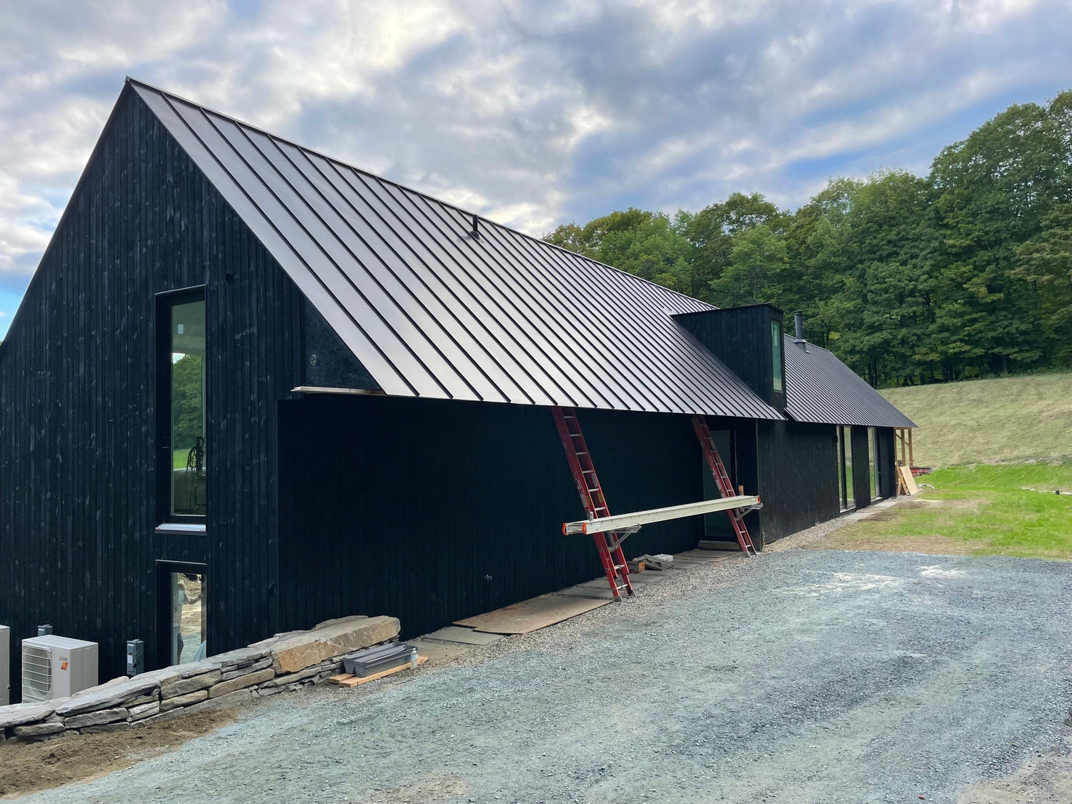 Nordic Style Farmhouse getting a coat of Palm Beach Black on raw timber siding