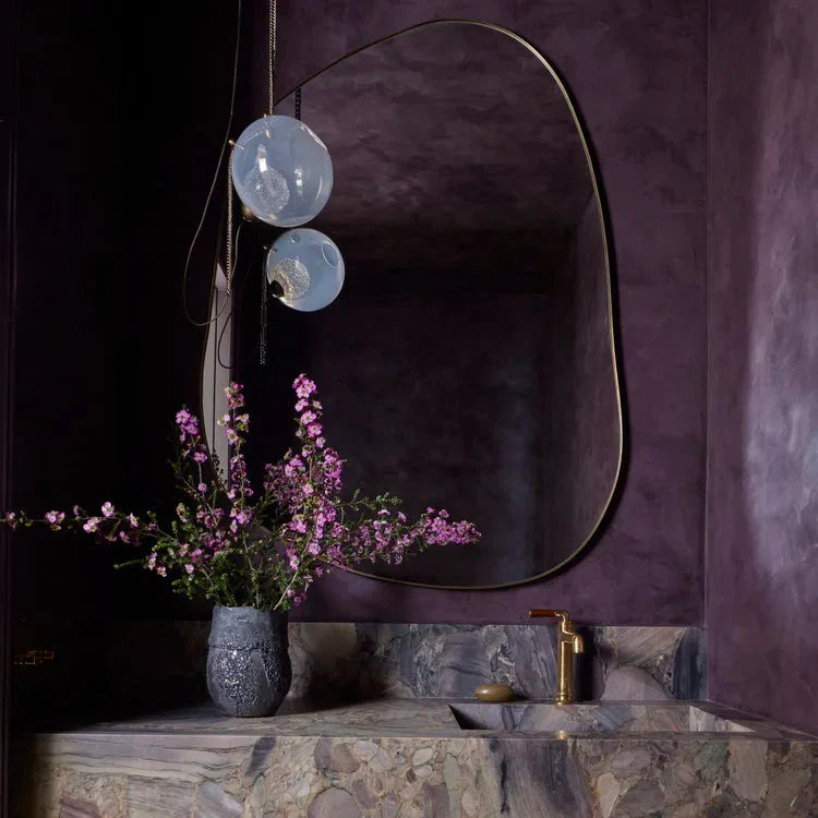SYDNEY_HARBOUR_FRESCO_PLASTERcolor is Aubergine. Bathroom powder room with natural stone countertop, oak wood cabinet, and decorative mirror.
