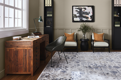 Modern home office with wooden desk, chairs, and abstract art on the wall. Sydney Harbour Paint Old Stone Wall in Eggshell: A mid neutral, with the cool earth tone of raw umber. Having both grey and green undertones enables it to pair easily with many other colors.  Olive Toned Grey Paint.
