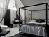 Half Wood Smoke eggshell in a modern bedroom with a four-poster bed, black and white decor, and a bathroom in the background.
