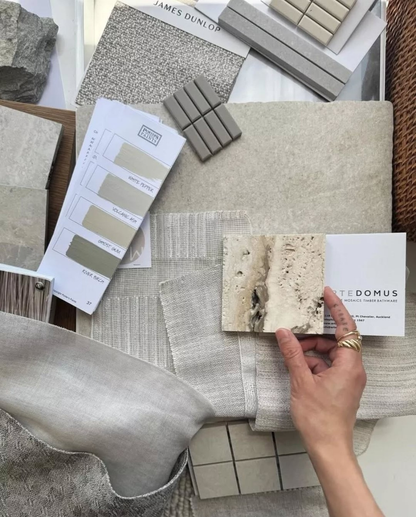 Collection of stone and tile samples with a hand holding a sample, set against Sydney Harbour Paint Company and Porters Original Paints Colors on a neutral background.